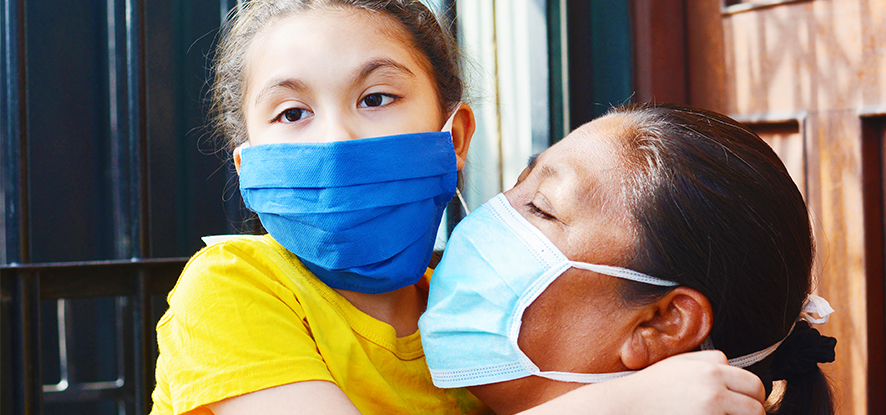 Latina mom and daughter wearing a protective face mask