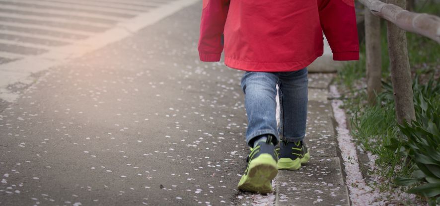 Child walking in street alone 