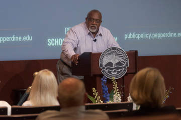 Glenn Loury at the podium giving a lecture 