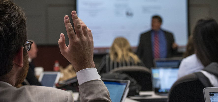 Student raising his hand in class - Pepperdine University