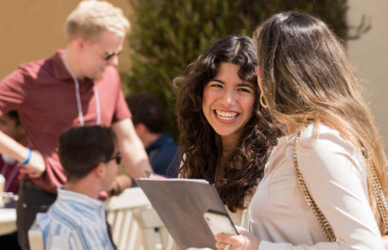 Public Policy students walking outdoors smiling 