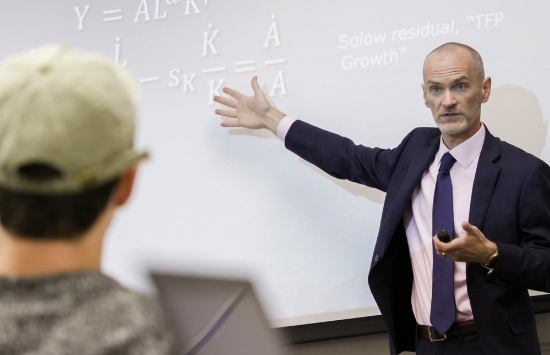 Dr. James Prieger teaching in front of classroom