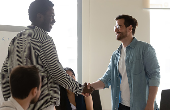 People shaking hands in a business setting