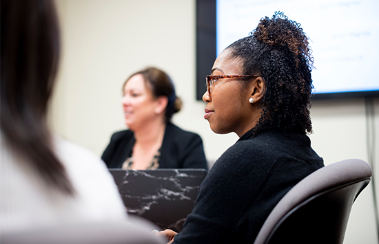 Students and professor talking at the table