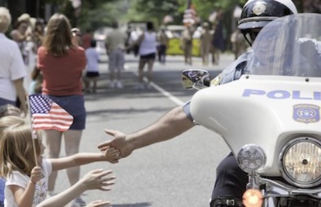 Police Officer giving a child a high-five