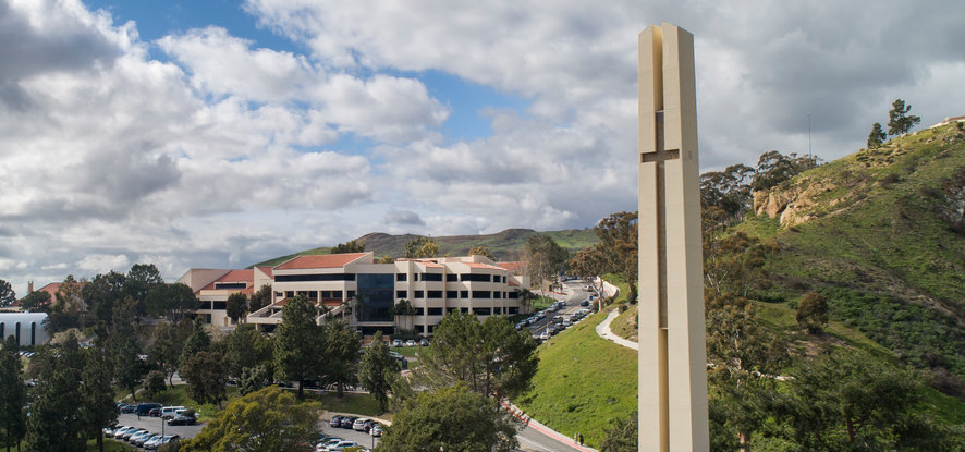 Pepperdine's campus view of cross statue, buildings, and hills