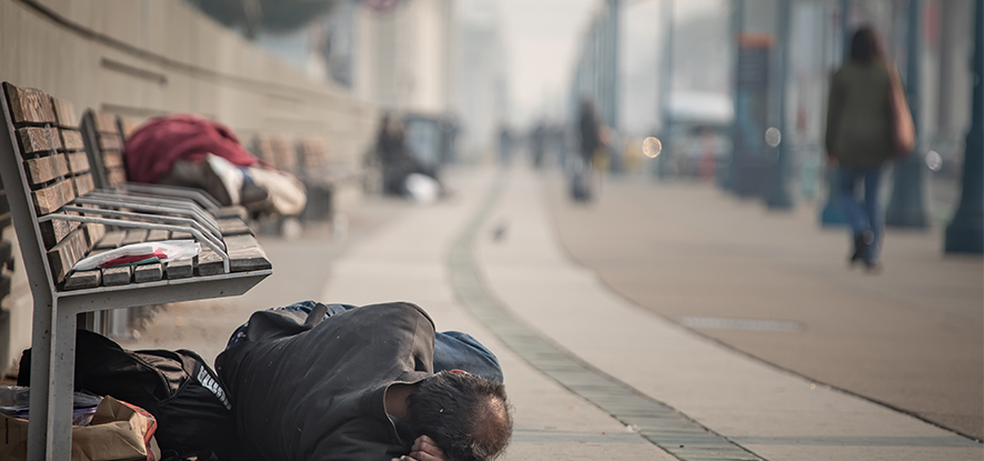 Homeless person sleeping on the ground