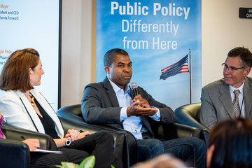 Three people sitting on a panel