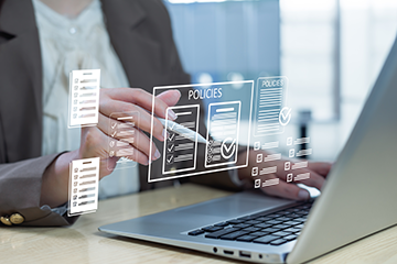 Person on laptop working on policies