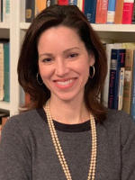 Elizabeth Spalding standing in front of a book case