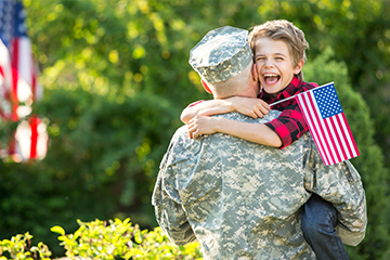 miltary dad hugging son