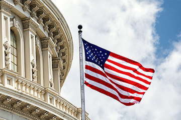 Close-up of the U.S. Capitol building with an American flag