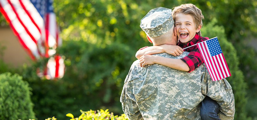 Son hugging military father