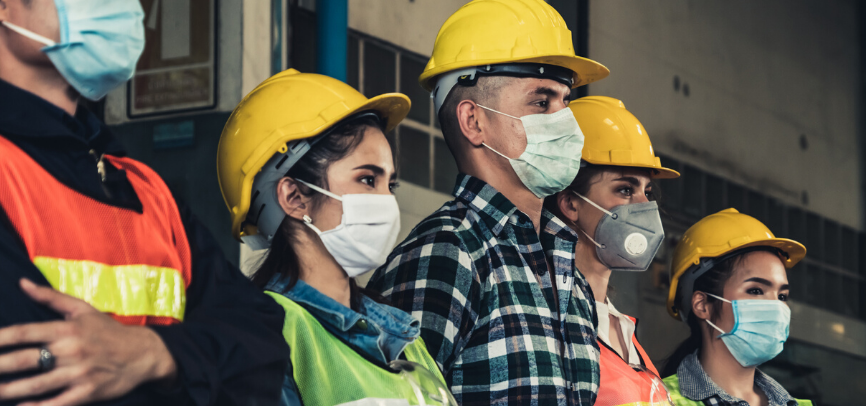 People wearing hardhats and masks during COVID-19