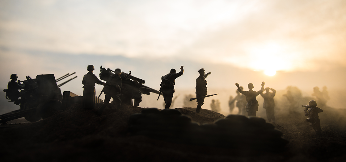 silhouettes of soldiers on a mountain