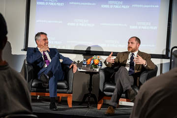 Dean Pete Peterson talking to Timothy Carney