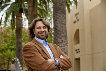 Faculty member Ted McAllister under palm trees