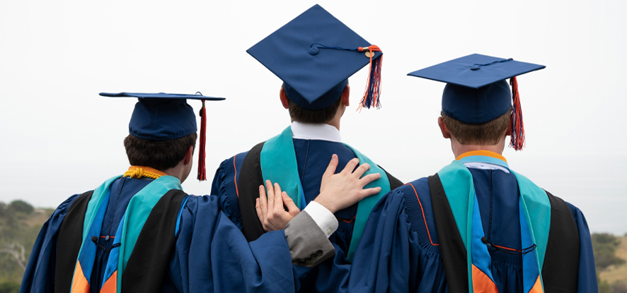 Three School of Public Policy graduates hugging each other