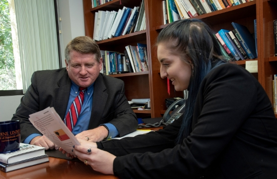 Dr. Michael Shires in office with SPP student looking over document