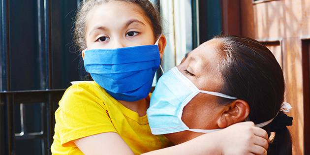 Mother and daughter wearing protective face mask 