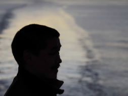 silhouette of a man by the beach water