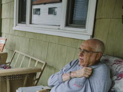 elder man sitting on porch