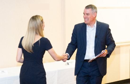 Dean Peterson shaking hands with a lady